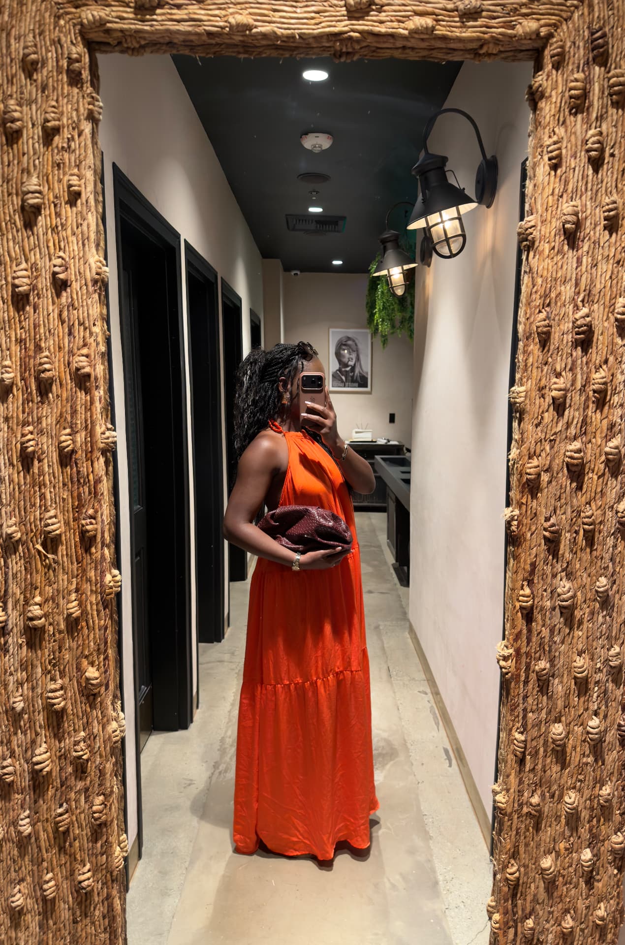 Julie Don in an orange satin maxi dress